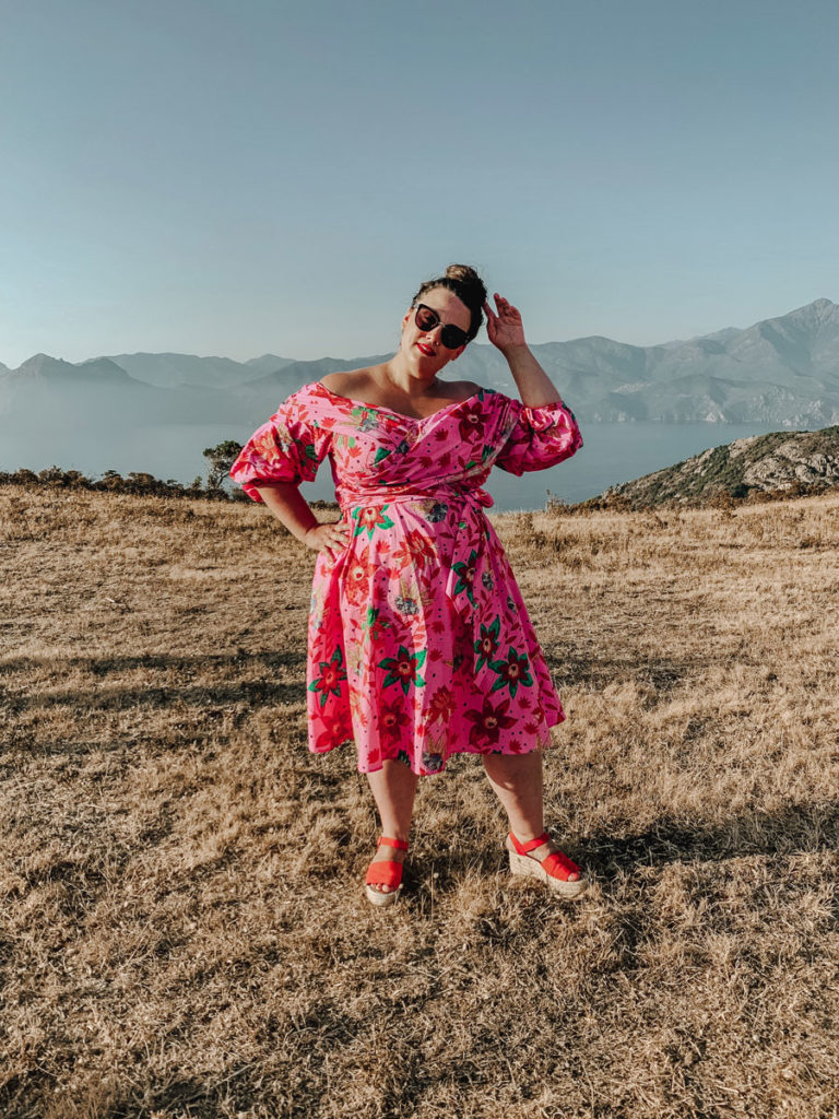 Plus Size Fat woman in bright colored dress traveling in Corsica France